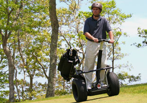 Man riding X2 Golf on hill